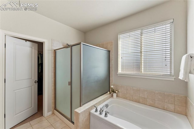 full bathroom with tile patterned floors, a spacious closet, a bath, and a shower stall