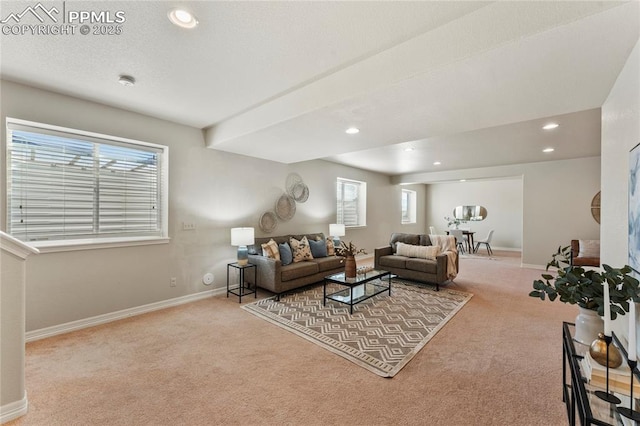 carpeted living area with recessed lighting, a textured ceiling, and baseboards