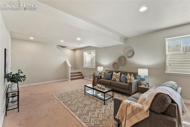 living area featuring stairway, baseboards, recessed lighting, a textured ceiling, and carpet flooring