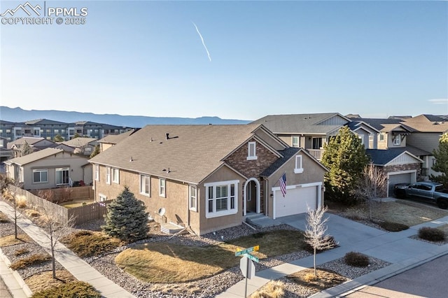 view of front of house with a residential view, stucco siding, and concrete driveway