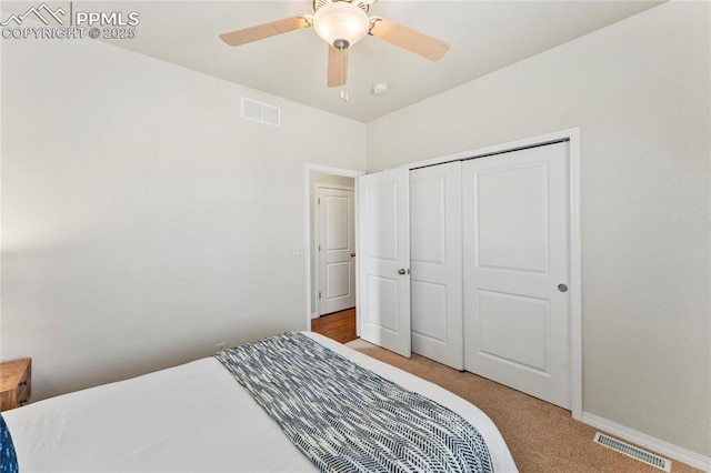 bedroom with light carpet, visible vents, baseboards, and ceiling fan