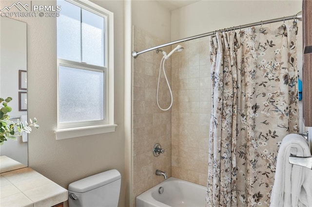 full bathroom with shower / bath combo with shower curtain and toilet