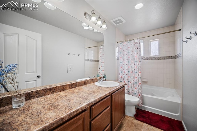 bathroom featuring toilet, vanity, visible vents, tile patterned floors, and shower / bathtub combination with curtain