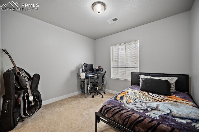 carpeted bedroom with visible vents and baseboards
