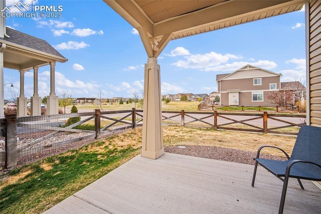view of patio / terrace featuring a residential view and a fenced backyard