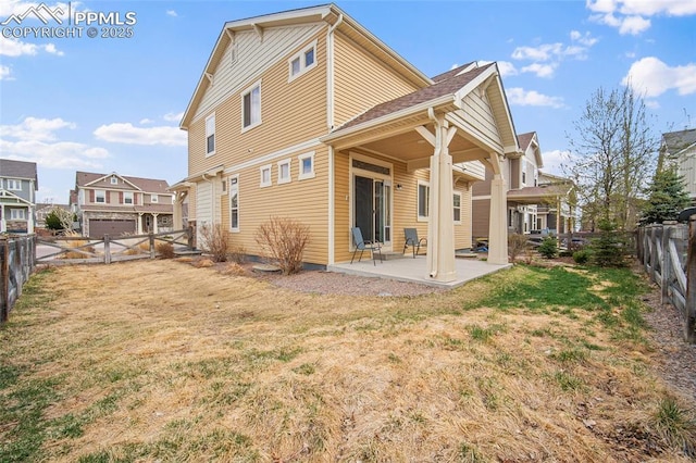 back of property featuring a lawn, a patio, and a fenced backyard