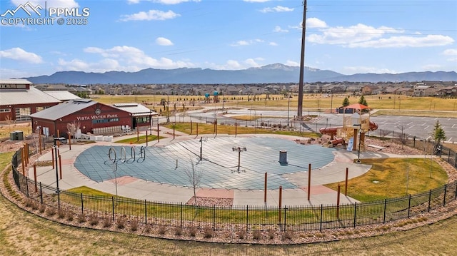 view of sport court with fence and a mountain view