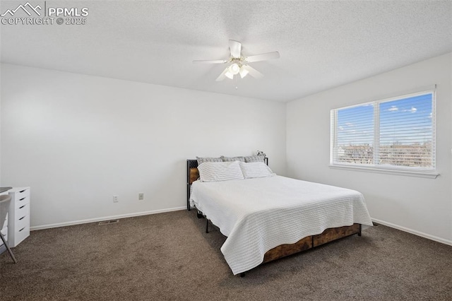 bedroom with ceiling fan, baseboards, carpet floors, and a textured ceiling