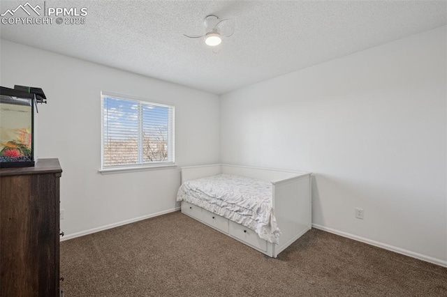 carpeted bedroom featuring baseboards and a textured ceiling