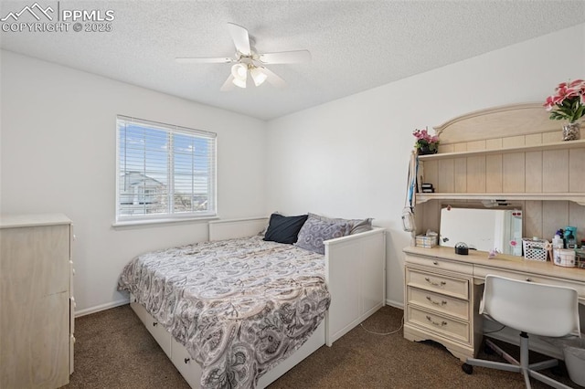 bedroom featuring a ceiling fan, carpet floors, and a textured ceiling