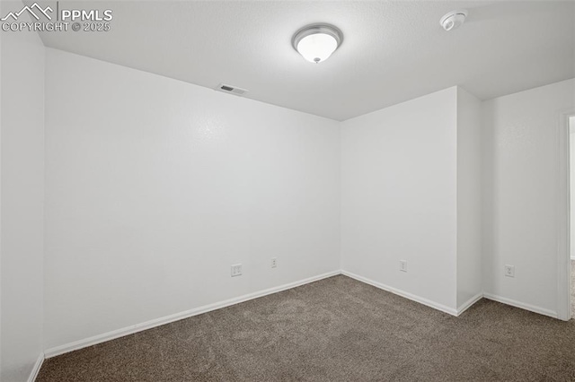 carpeted empty room featuring visible vents and baseboards