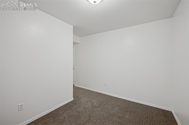 empty room featuring baseboards and carpet floors