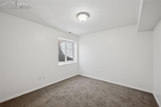 empty room with visible vents, baseboards, and carpet