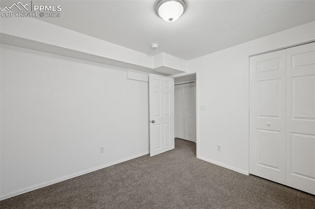 unfurnished bedroom with baseboards and carpet floors