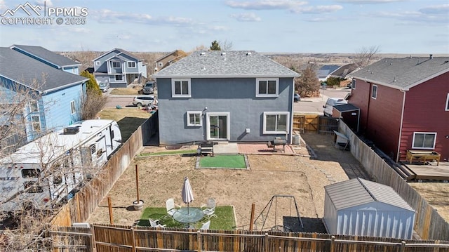 back of house featuring a patio area, a fenced backyard, a residential view, and stucco siding