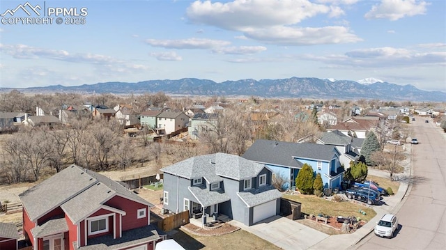 birds eye view of property with a mountain view and a residential view