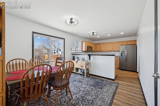 dining space featuring light wood finished floors, recessed lighting, and baseboards