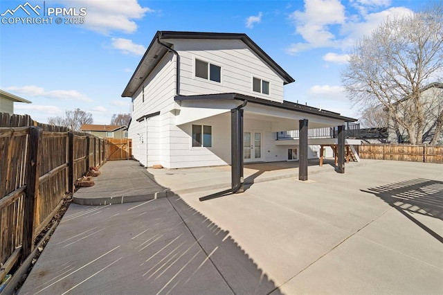 rear view of property with a patio area, french doors, and a fenced backyard