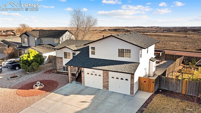 view of front of home with brick siding, roof with shingles, driveway, and fence