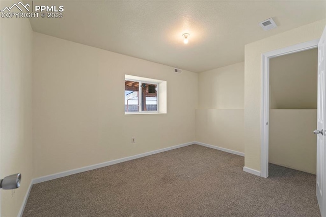 empty room with visible vents, baseboards, and carpet floors