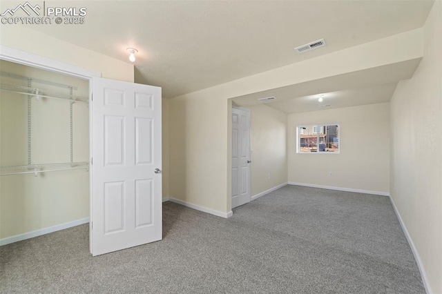 unfurnished bedroom featuring a closet, visible vents, baseboards, and carpet