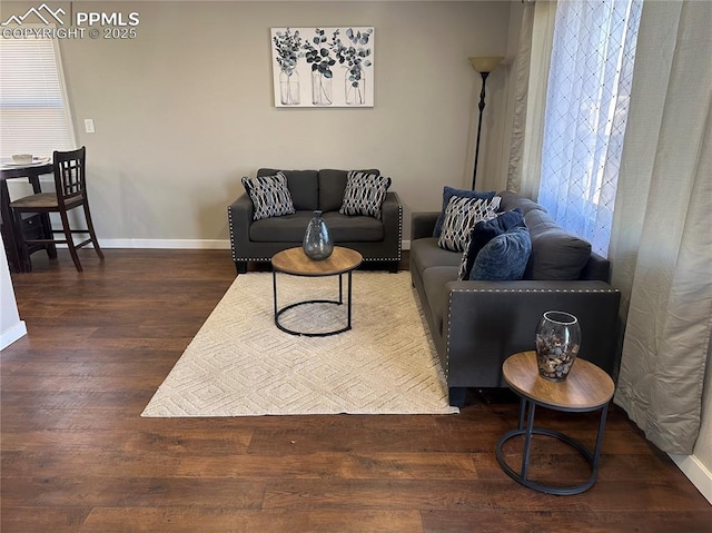 living room featuring wood finished floors and baseboards