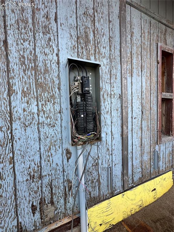 exterior details with electric panel and crawl space