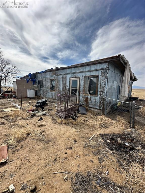 rear view of property with fence