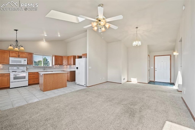 kitchen featuring white appliances, light colored carpet, and light countertops