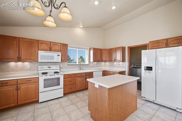 kitchen with light tile patterned floors, white appliances, light countertops, and washing machine and clothes dryer