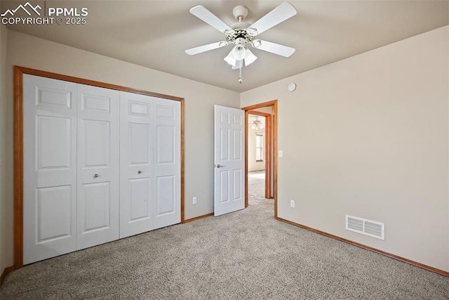 unfurnished bedroom with a ceiling fan, carpet, visible vents, baseboards, and a closet