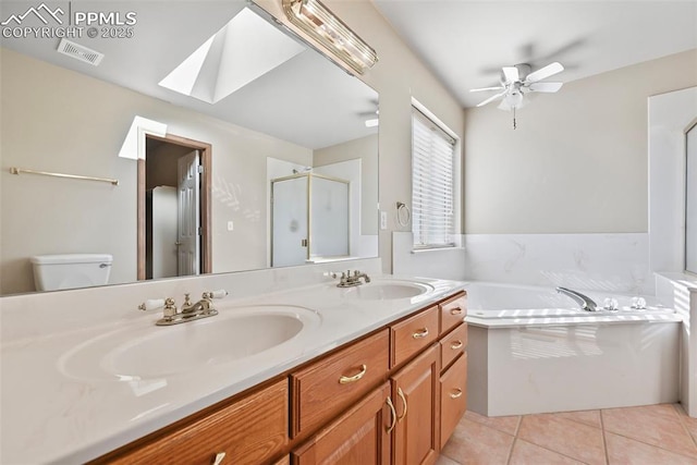 full bathroom with tile patterned floors, visible vents, a skylight, and a sink