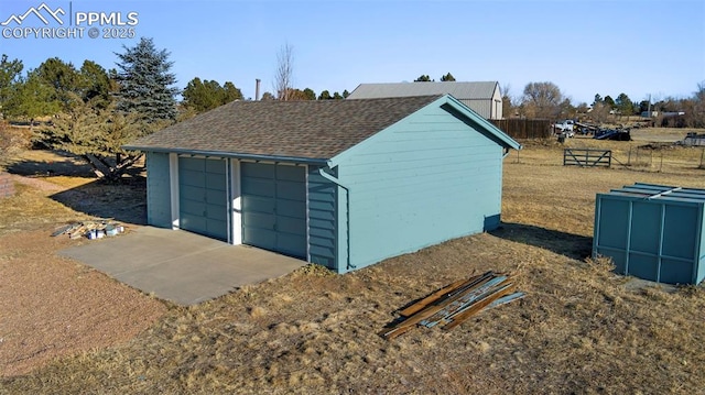 view of outdoor structure featuring an outbuilding and fence