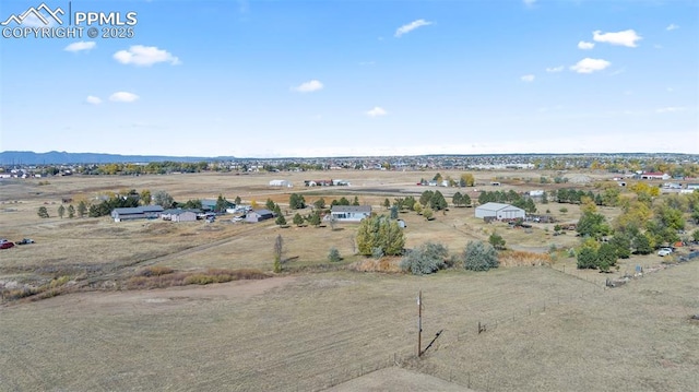 drone / aerial view featuring a rural view and a mountain view