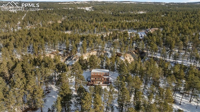 birds eye view of property with a view of trees