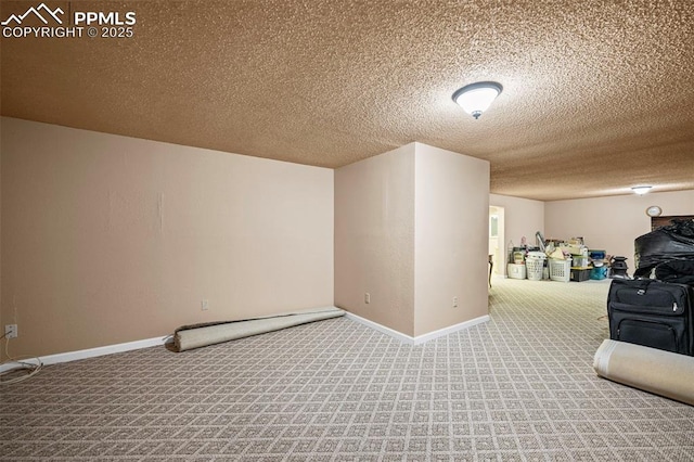 interior space with baseboards, carpet floors, and a textured ceiling