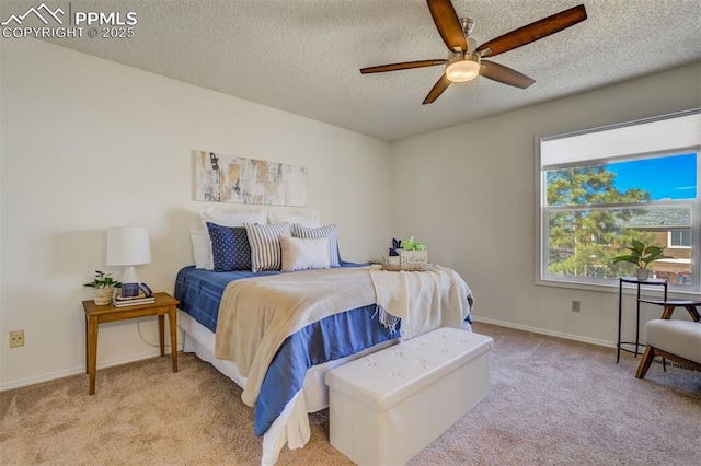 bedroom featuring baseboards, carpet floors, a textured ceiling, and a ceiling fan