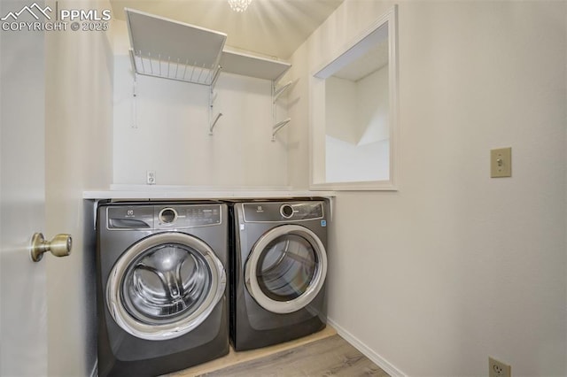 laundry room featuring washer and dryer, laundry area, wood finished floors, and baseboards