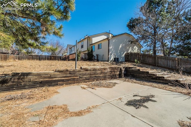 exterior space featuring a patio area, central AC, and a fenced backyard