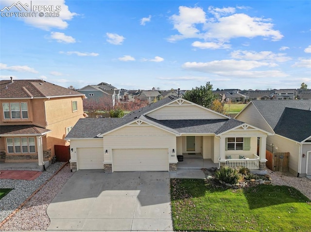 view of front of house featuring a garage, a residential view, a porch, and concrete driveway