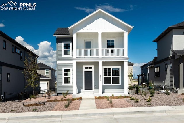 view of front of property with a balcony, fence, and board and batten siding