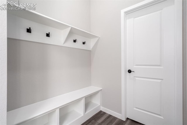 mudroom featuring dark wood finished floors and baseboards