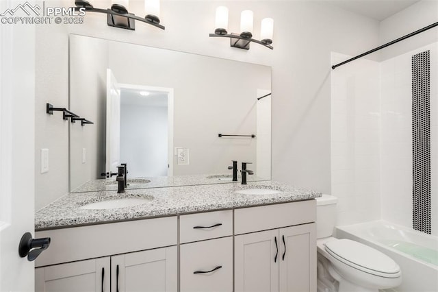 bathroom featuring double vanity, toilet, shower / bath combination, and a sink