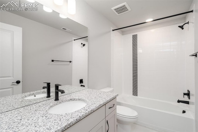 bathroom featuring visible vents, toilet, vanity, and washtub / shower combination