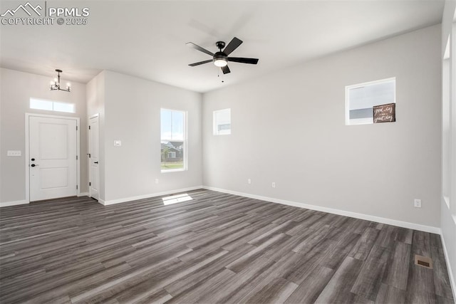 interior space with dark wood finished floors, visible vents, ceiling fan with notable chandelier, and baseboards