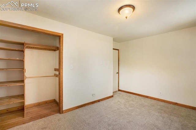 unfurnished bedroom featuring a closet, baseboards, and carpet