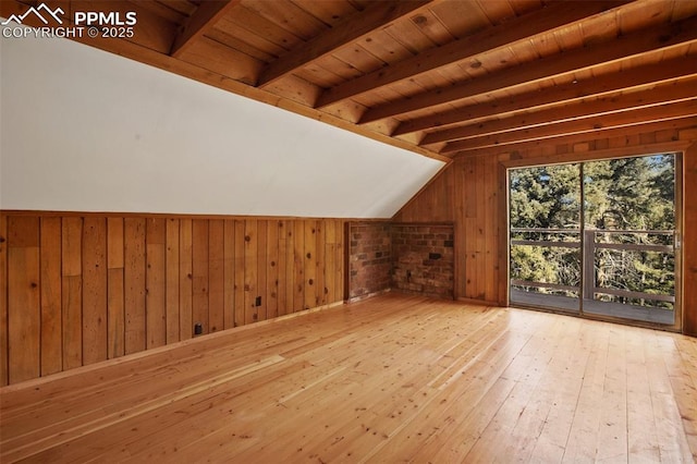 additional living space with wood walls, wood ceiling, lofted ceiling with beams, and wood-type flooring