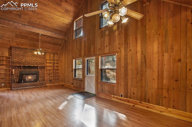 unfurnished living room featuring wooden walls, built in features, wood ceiling, vaulted ceiling, and wood finished floors