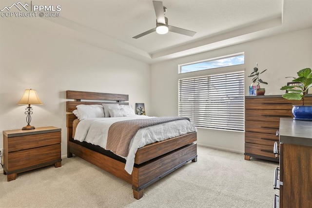 4478 Riviera Ct, Aurora, CO 80019 - bedroom featuring light carpet, a ceiling fan, a raised ceiling, and baseboards