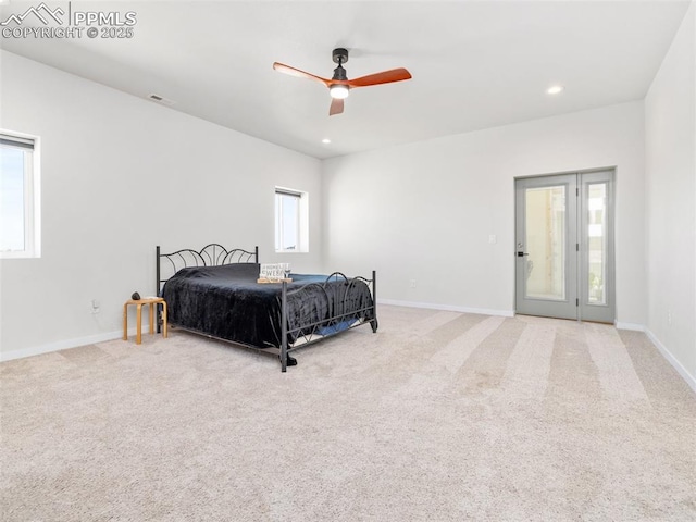 carpeted bedroom featuring recessed lighting, multiple windows, and baseboards